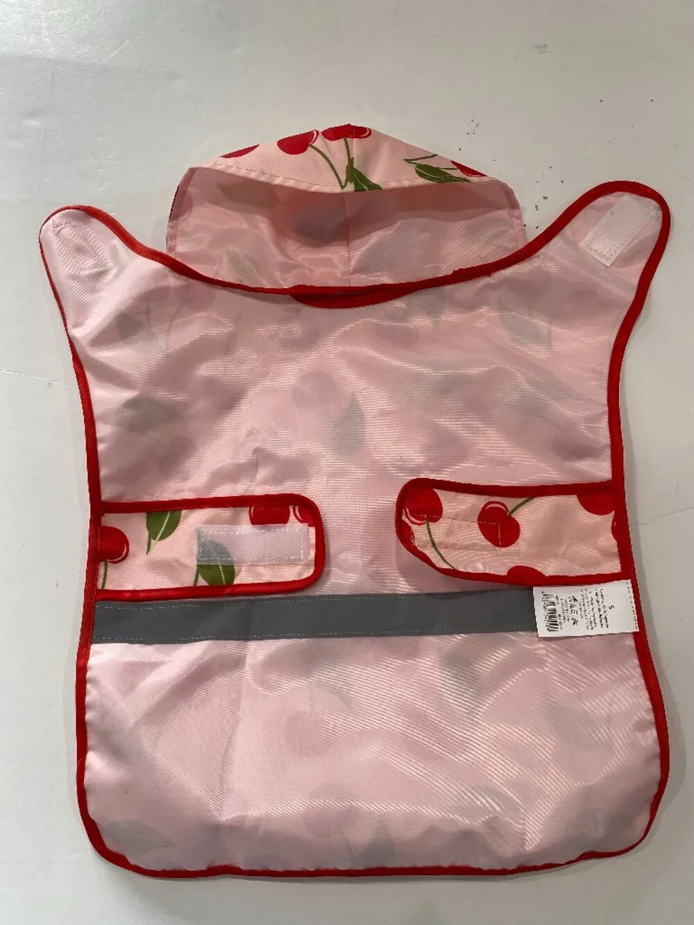 Cherry NWOT small dog raincoat with hood and reflective strip.